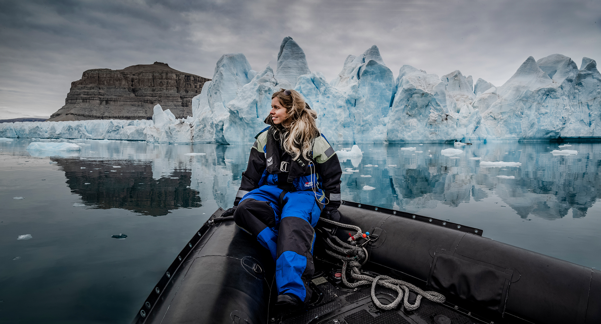 Stephanie on a boat in front of Arctic icebergs